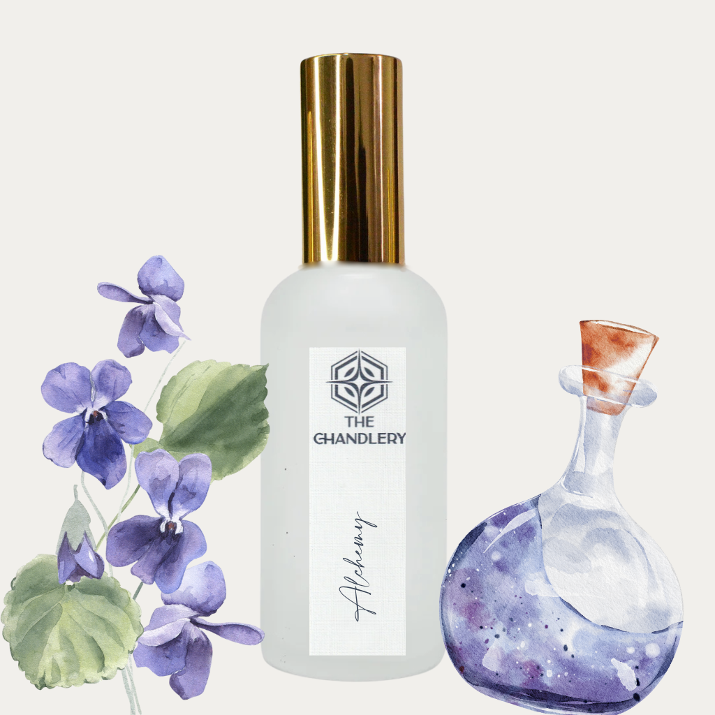 Bottle of Alchemy room spray with violets and potion bottle in the background