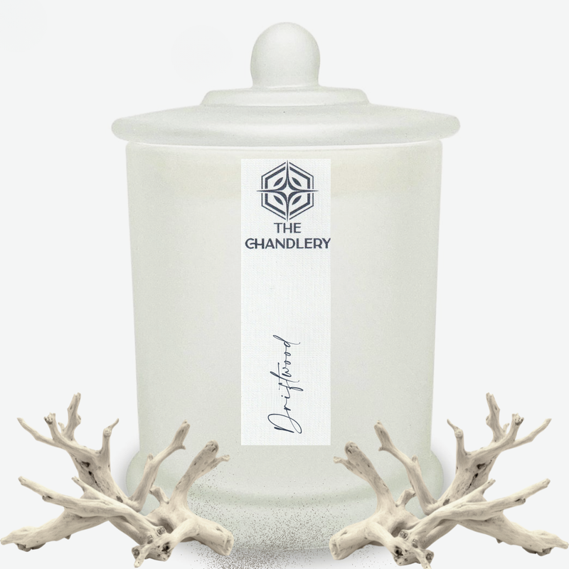 Driftwood apothecary candle in frosted glass with lid, illustrated with bleached driftwood