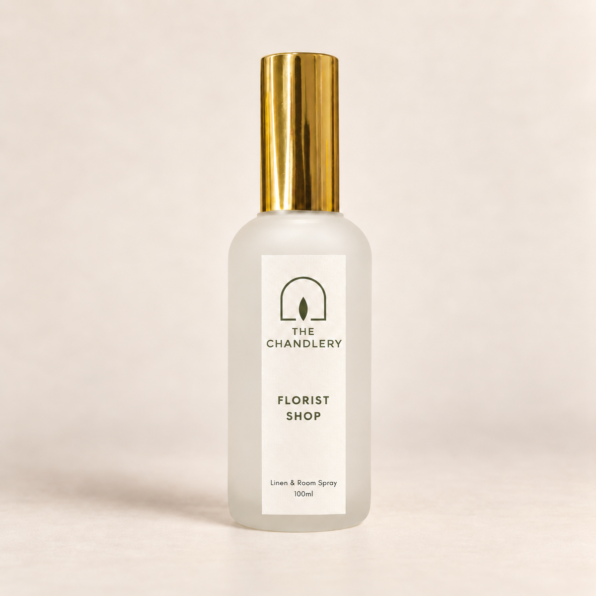 The Chandlery Florist Shop room spray in a frosted glass bottle with a gold spray top, photographed against a soft neutral backdrop.