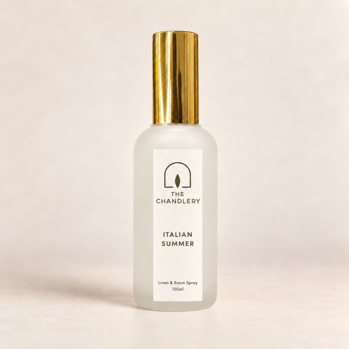 The Chandlery Italian Summer room spray in a frosted glass bottle with a gold spray top, photographed against a soft neutral backdrop.