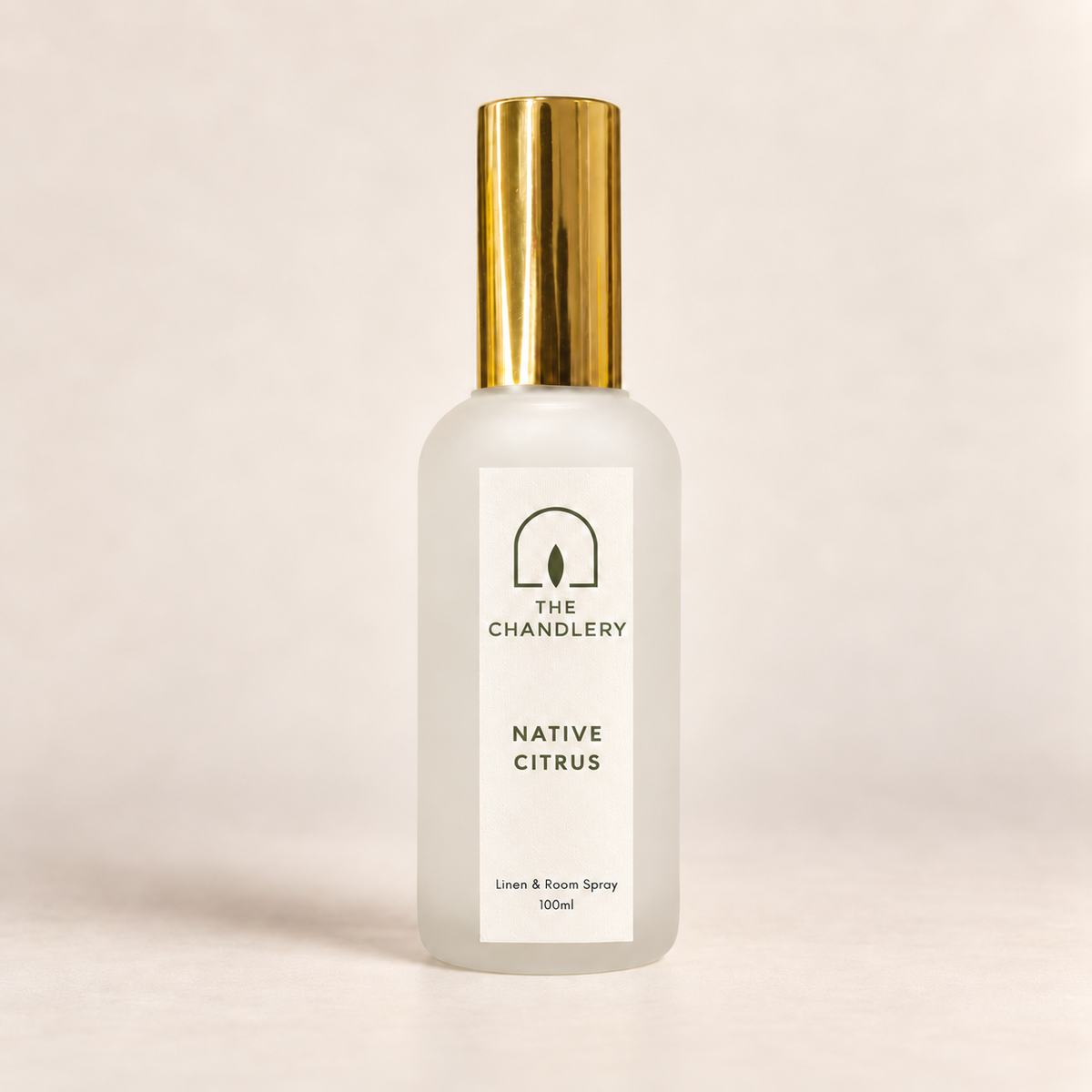 The Chandlery Native Citrus room spray in a frosted glass bottle with a gold spray top, photographed against a soft neutral backdrop.