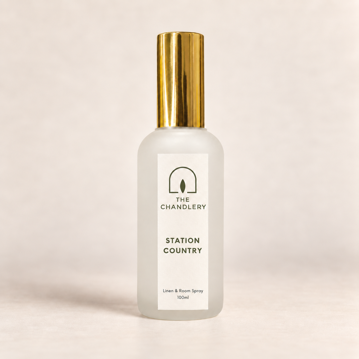 The Chandlery Station Country room spray in a frosted glass bottle with a gold spray top, photographed against a soft neutral backdrop.