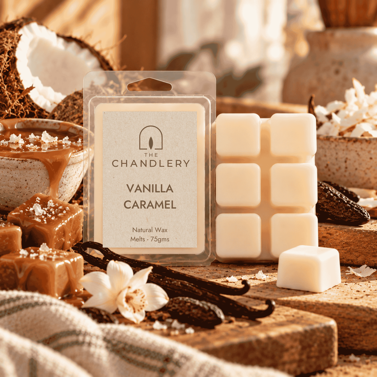 Vanilla Caramel wax melt packet and ivory six-cube bar with a loose cube, caramel, coconut and vanilla pods.