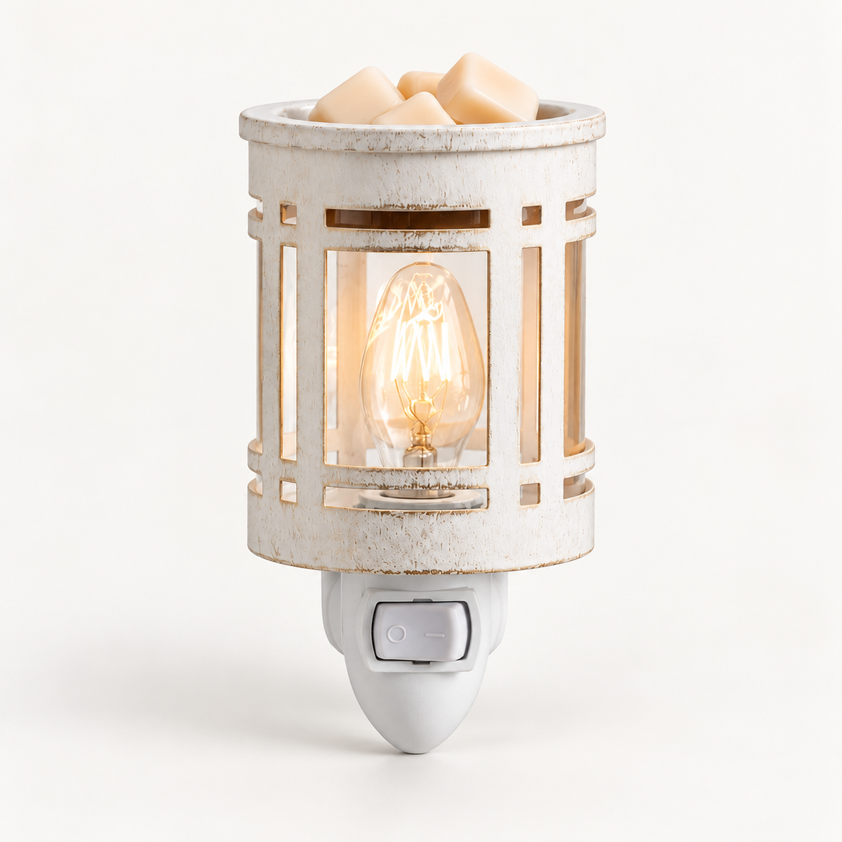 The Chandlery white lantern plug-in wax warmer with a glowing bulb and wax melts